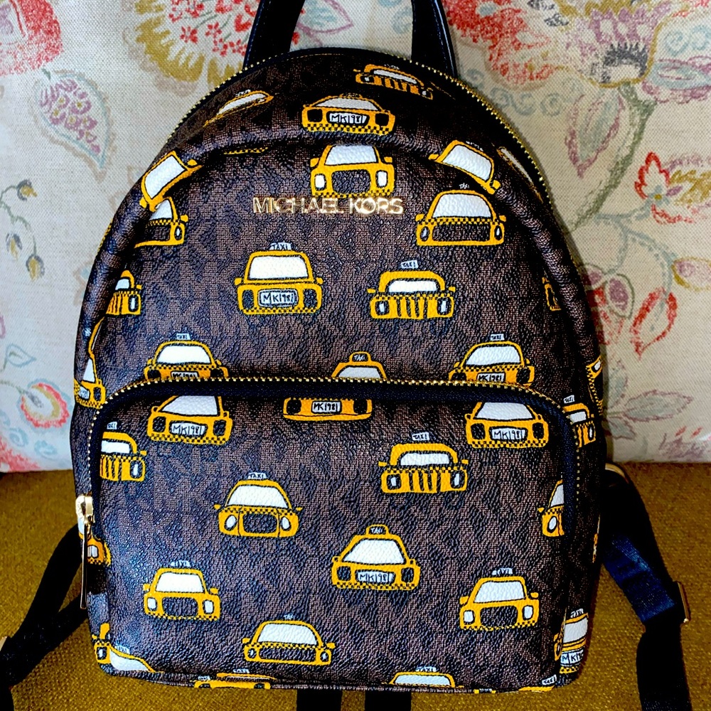 Michael Kors Taxi Backpack purse (NOT FOR SALE) (HOLDING)
